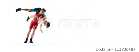Young male athletes engage in physical contest, wrestling with determination and focus isolated on white background. Banner 113730487