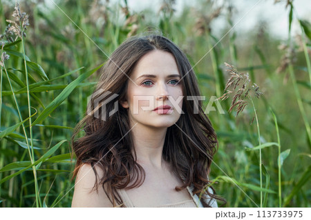 Gorgeous healthy young brunette woman with fresh clear skin and long dark brown hair outdoors Gorgeous healthy young brunette woman with fresh clear skin and long dark brown hair outdoors 113733975