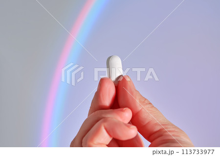 Tablet in hand against the background of a glowing circle. Tablet in hand against the background of a glowing circle. 113733977