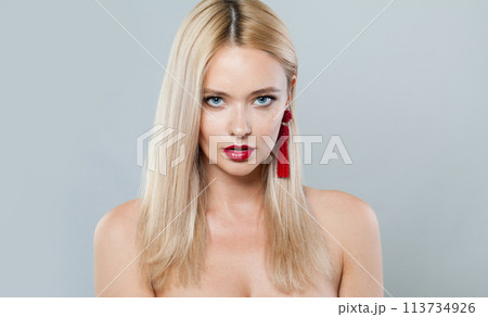 Beauty fashion model woman with blonde hair wears big red color earrings. Fashionable lady 113734926