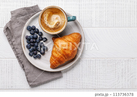 Cappuccino coffee and fresh croissant Cappuccino coffee and fresh croissant 113736378