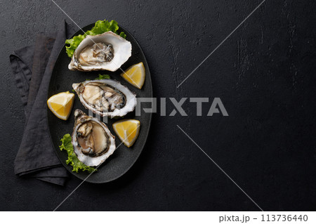 Fresh oysters with lemon on plate Fresh oysters with lemon on plate 113736440