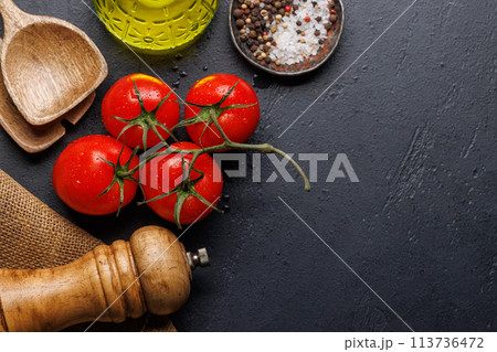 Spices, olive oil, and utensils on cooking table 113736472