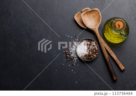 Spices, olive oil, and utensils on cooking table 113736484