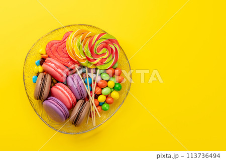 Various colorful candies, lollipops, and macaroons Various colorful candies, lollipops, and macaroons 113736494