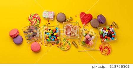 Various colorful candies, lollipops, and macaroons Various colorful candies, lollipops, and macaroons 113736501