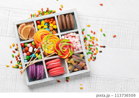 Various colorful candies, lollipops, and macaroons 113736509