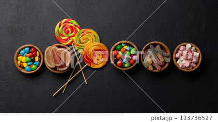 Various colorful candies, lollipops, and macaroons Various colorful candies, lollipops, and macaroons 113736527