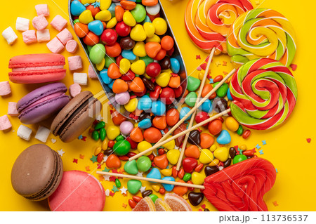 Various colorful candies, lollipops, and macaroons Various colorful candies, lollipops, and macaroons 113736537