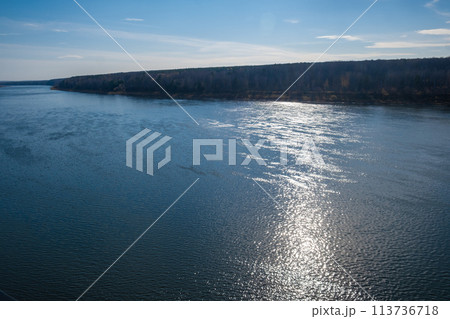 Beautiful, wide autumn river among forests and rocky shore. 113736718