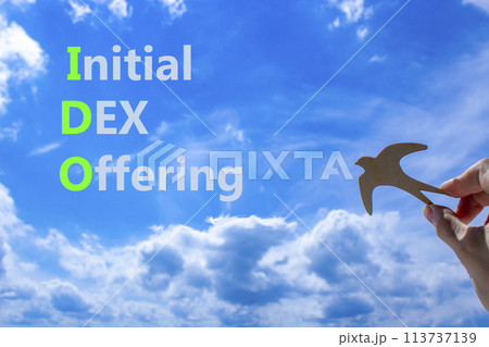IDO initial DEX offering symbol. Concept words IDO initial DEX offering on beautiful blue sky clouds background. Wooden bird. Businessman hand. Business IDO initial DEX offering concept. Copy space. IDO initial DEX offering symbol. Concept words IDO initial DEX offering on beautiful blue sky clouds background. Wooden bird. Businessman hand. Business IDO initial DEX offering concept. Copy space. 113737139