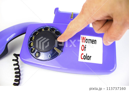 WOC women of color symbol. Concept words WOC women of color on beautiful old disk phone. Beautiful white background. Businessman hand. Business WOC women of color social issues concept. Copy space. WOC women of color symbol. Concept words WOC women of color on beautiful old disk phone. Beautiful white background. Businessman hand. Business WOC women of color social issues concept. Copy space. 113737160