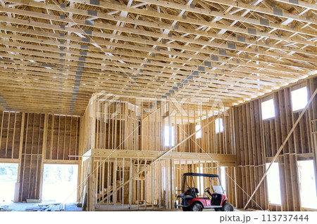 Beams at wooden trusses framework construction on a new house under construction 113737444