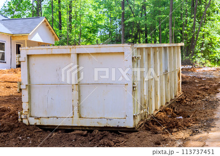 During renovation of a house, garbage container bins are used to collect construction waste During renovation of a house, garbage container bins are used to collect construction waste 113737451