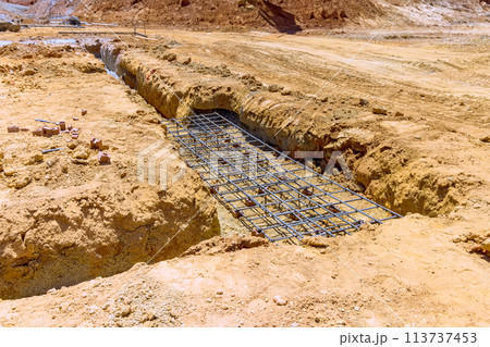 Earthworks, digging earthen trench dug for foundations to pouring a concrete 113737453