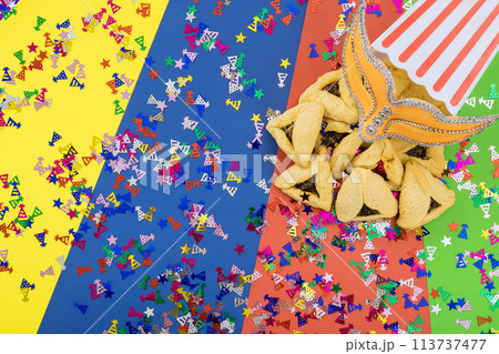 Purim is Jewish festival of remembrance, which is celebrated with carnival mask a hamantaschen cookies 113737477