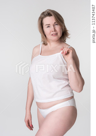 Woman in underwear on white background. Concept is about promoting healthy lifestyle and body inclusivity, particularly for mid adults, those who body conscious, those wear extended sizes or curvy 113743487