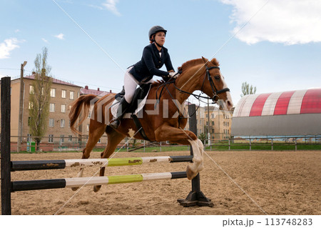Rider jumping horse over obstacle, equestrian sport. Rider jumping horse over obstacle, equestrian sport. 113748283
