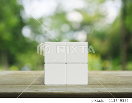 Four white block cubes on wooden table 113749585