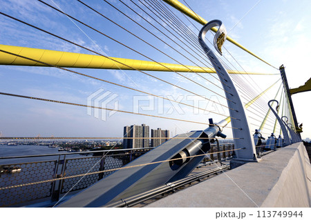 Yellow Cables On A Suspension Bridge Against Blue Sky In Bangkok. Yellow Cables On A Suspension Bridge Against Blue Sky In Bangkok. 113749944