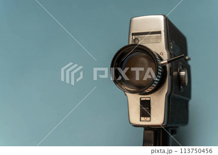 A close-up of a vintage movie camera shooting on 8 mm film from the 80s A close-up of a vintage movie camera shooting on 8 mm film from the 80s 113750456