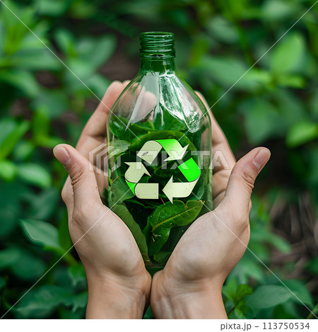 Person Holding Green Bottle With Recyclable Symbol. zero waste, sustainability, social cause 113750534