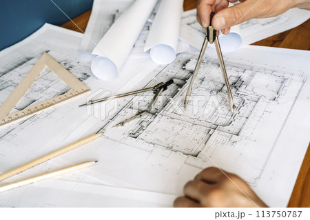 Architectural engineering design plan drawing on the table. Architect's work on table in studio. Construction design and plan 113750787