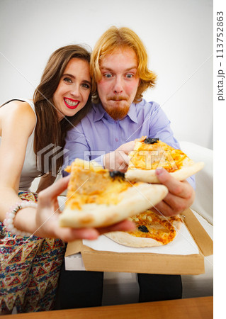 Funny couple eating pizza Funny couple eating pizza 113752863