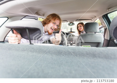 Happy man and woman in car 113753180