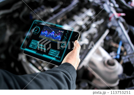 Car mechanic checking ECU electronic control unit with OBD or OBD2 wireless scanner tool 113753251