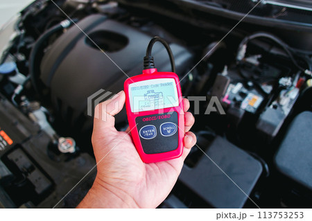 OBD2 or OBD scanner in a auto mechanic hand for engine system analysis 113753253