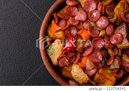 Grilled potatoes cut into slices with hunting sausages with garlic, onion Grilled potatoes cut into slices with hunting sausages with garlic, onion 113754241