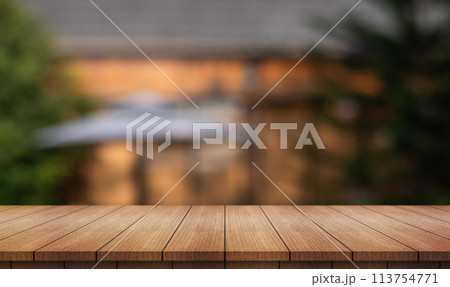 Empty wooden table top with lights bokeh on blur restaurant background. 113754771