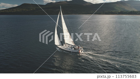 Sun light at sea bay with luxury yacht reflection aerial. Epic passenger sailboat cruise at open ocean. Tourism and travel lifestyle. Summer vacation scenery at sunshine. Cinematic seascape 113755683