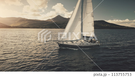 Brodick Harbour, Arran Island, Scotland. Luxury yacht travel at sun shine sea bay aerial. Sailing on motor boat in wind at ocean harbor. Amazing nature seascape at summer. Marine vacation 113755753