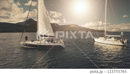 Brodick Harbour, Arran Island, Scotland. Luxury yachts at sun shine regatta aerial. Sailing in wind at open sea. Epic seascape of ocean bay. Summer cruise on boats. Cinematic drone shot Brodick Harbour, Arran Island, Scotland. Luxury yachts at sun shine regatta aerial. Sailing in wind at open sea. Epic seascape of ocean bay. Summer cruise on boats. Cinematic drone shot 113755765