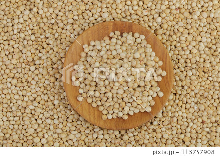 background of sorghum seeds with wooden bowl. Top view. Flat lay. 113757908