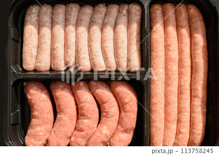 Fresh assorted sausages for preparation barbecue grill in black package. Fresh assorted sausages for preparation barbecue grill in black package. 113758245