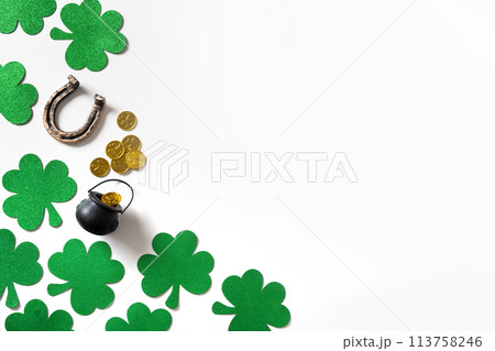 St. Patrick's day black pot with coins on green background. 113758246