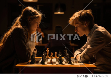 Two young individuals deeply engrossed in a strategic game of chess, competition under soft lighting Two young individuals deeply engrossed in a strategic game of chess, competition under soft lighting 113760280