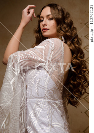 Beautiful girl posing in a boho style wedding dress 113762125