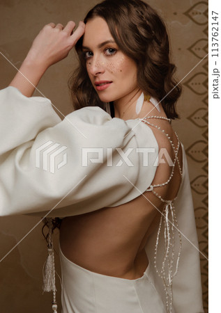 Beautiful girl posing in a boho style wedding dress 113762147