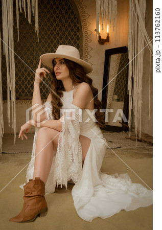 Beautiful girl posing in a boho style wedding dress 113762160