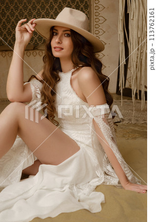 Beautiful girl posing in a boho style wedding dress 113762161