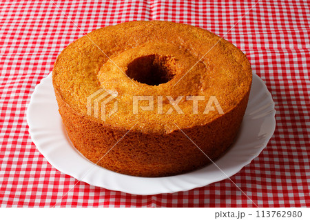 corn cake on white plate on rustic wooden table. Typical Brazilian party food. corn cake on white plate on rustic wooden table. Typical Brazilian party food. 113762980