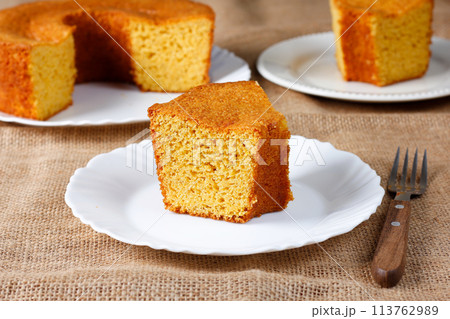 corn cake on white plate on rustic wooden table. Typical Brazilian party food. corn cake on white plate on rustic wooden table. Typical Brazilian party food. 113762989