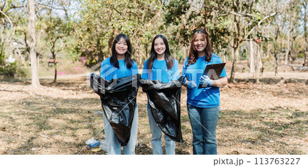 Group of volunteers, community members cleaning the nature from garbage and plastic waste to send it for recycling 113763227