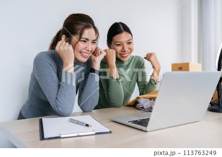 asian SME business women use laptop computer checking customer order online shipping boxes and happy after working success at home asian SME business women use laptop computer checking customer order online shipping boxes and happy after working success at home 113763249