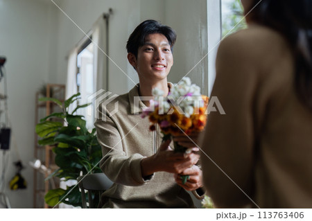 Young couple Hug and giving flower on Valentine's Day. Romantic day together. Valentine's Day concept Young couple Hug and giving flower on Valentine's Day. Romantic day together. Valentine's Day concept 113763406