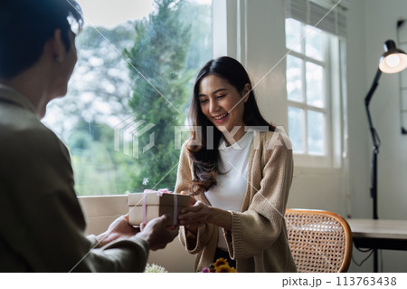 Young couple Hug and giving present on Valentine's Day. Romantic day together. Valentine's Day concept 113763438